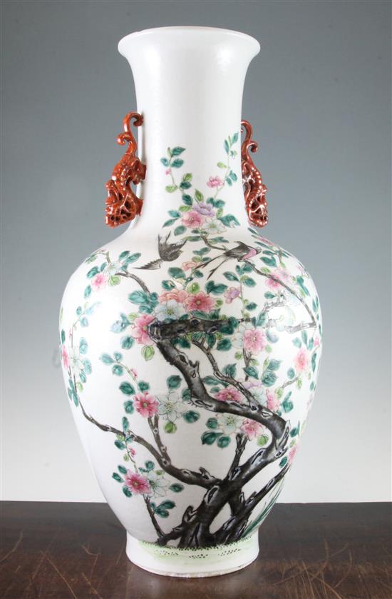 A large Chinese famille rose twin handled bottle vase, Qianlong seal mark, late 19th century, 54cm., foot ground off in manufacture